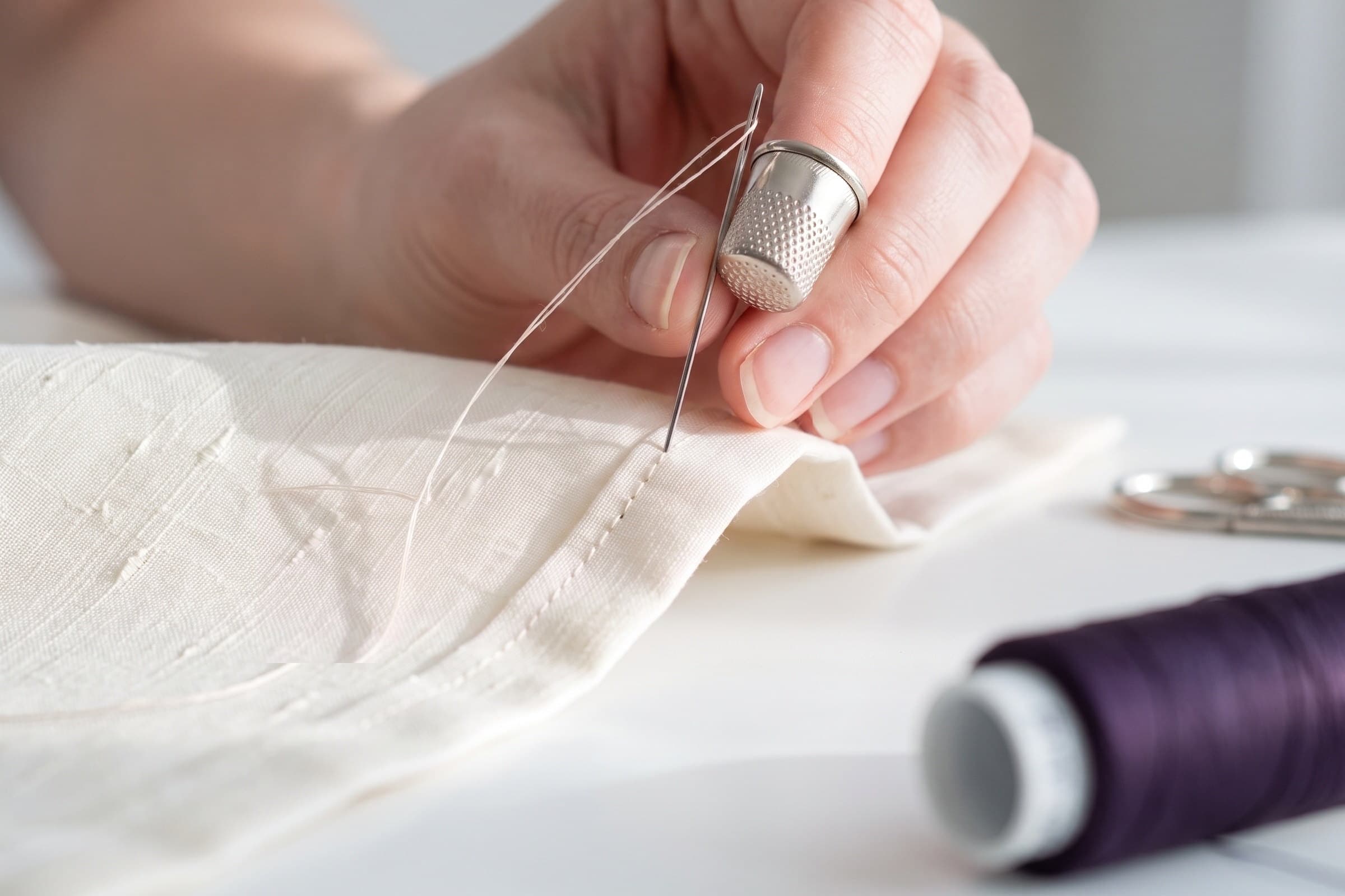 A tailor performing an alteration by hand in-house at Sir Galloway.