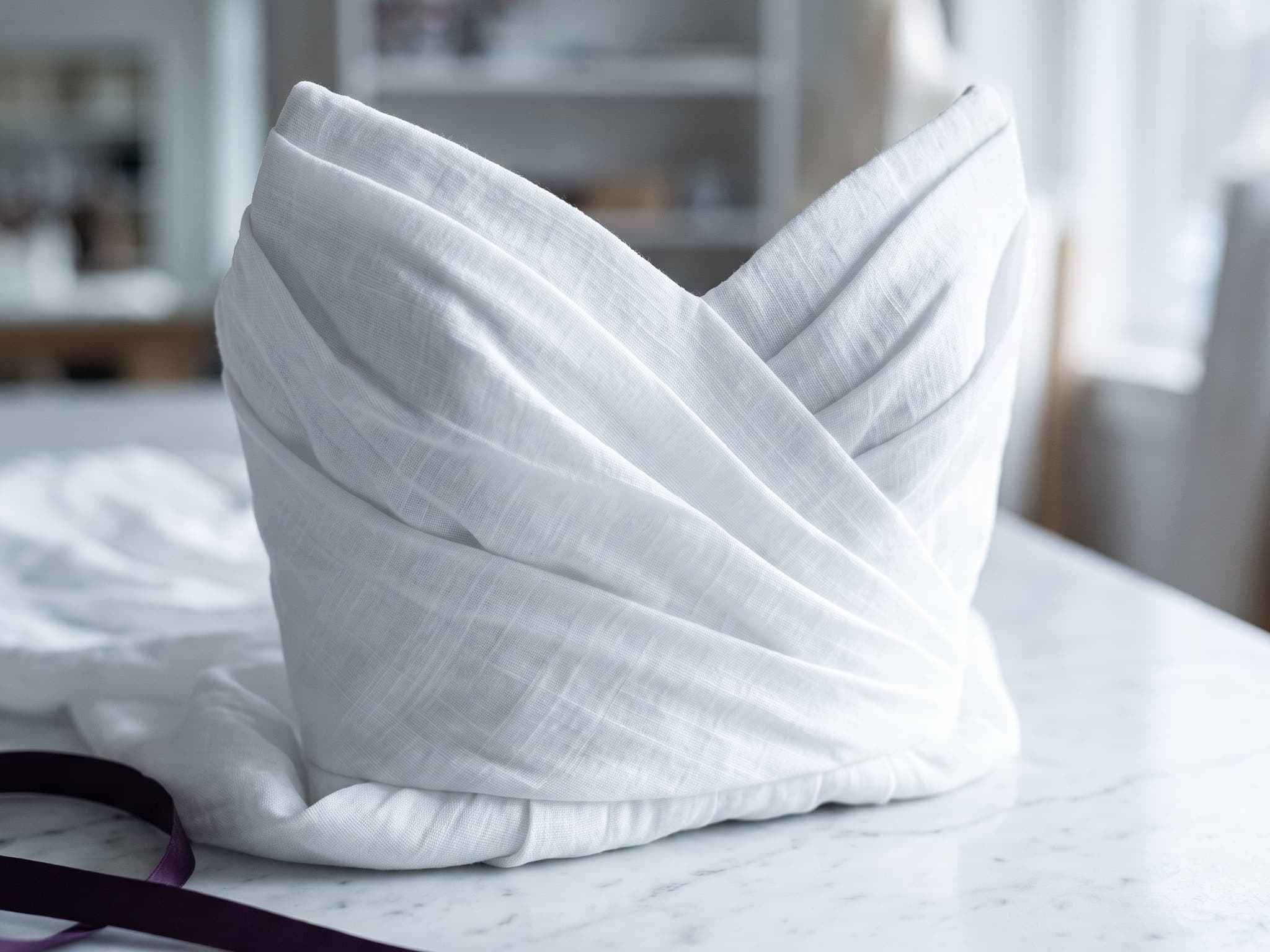 A wedding gown wrapped in acid-free muslin.