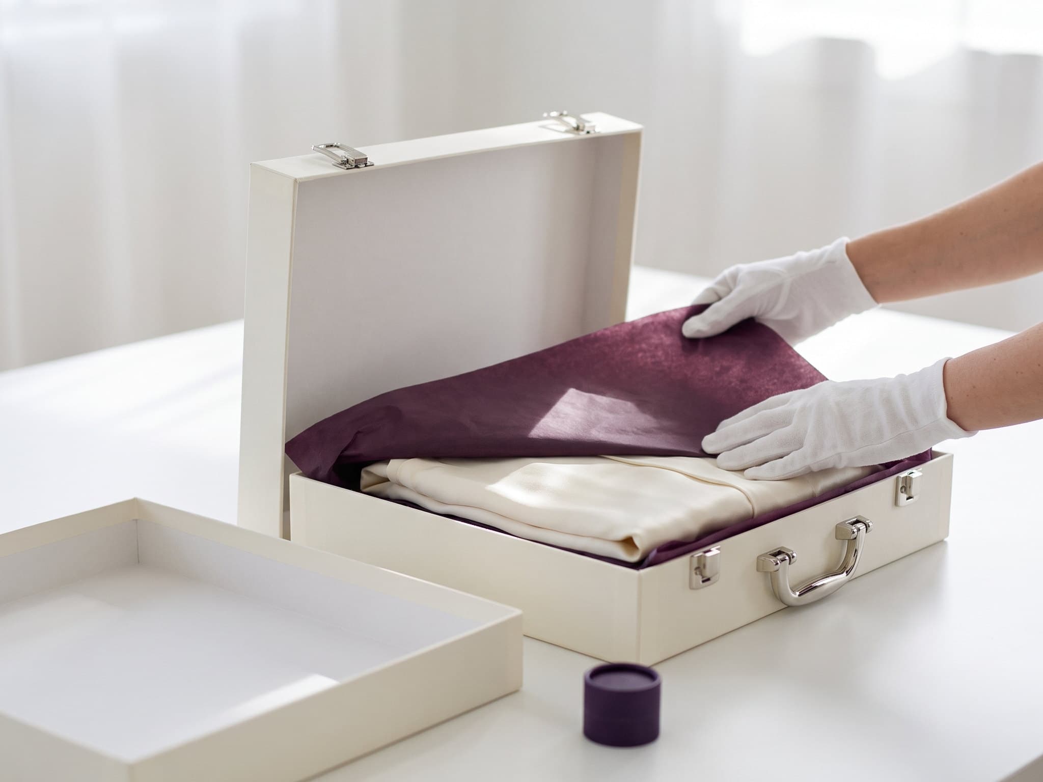 A wedding gown set into the archival preservation box.