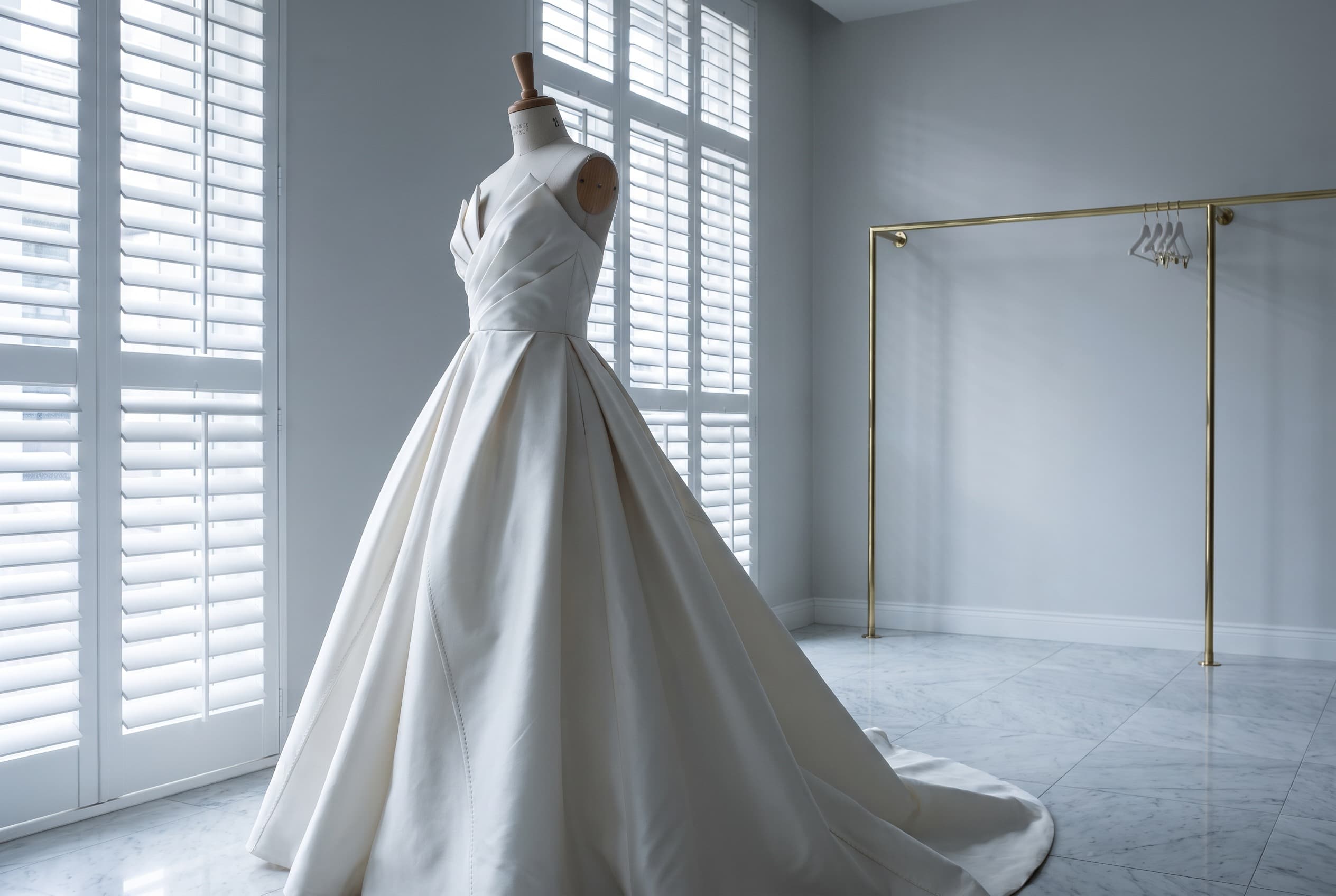 An ivory couture wedding gown displayed at Lady Galloway Gowns.
